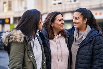 Three woman mother and daughters standing together at street
