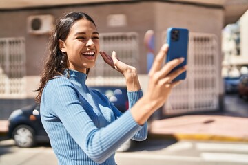 Young african american woman smiling confident having video call at street