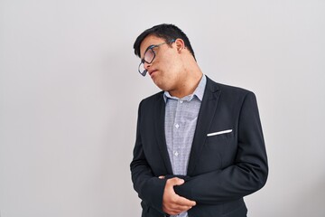 Young hispanic man with down syndrome wearing business style with hand on stomach because nausea,...