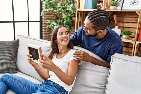 Man and woman couple smiling confident looking photo at home