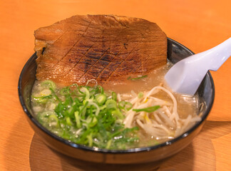 Bowl of a Japanese Tonkotsu ramen noodles originated from the Hakata district in Fukuoka served...
