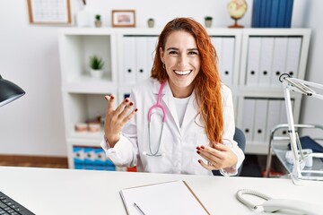 Fototapeta na wymiar Young redhead woman wearing doctor uniform speaking at hospital