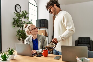 Businessman pouring coffee to his worker partner at the office