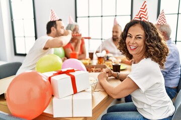 Group of middle age friends smiling happy celebrate birthday at home.