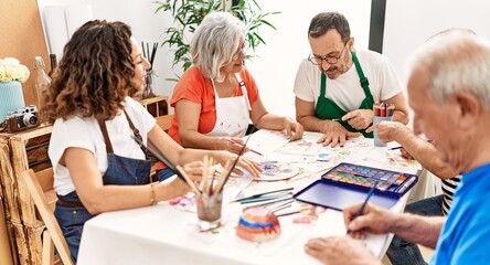 Fototapeta premium Group of middle age draw students sitting on the table drawing at art studio.