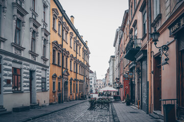 Fototapeta na wymiar Traditional buildings in a cobblestone street in historical Old town of Lviv.