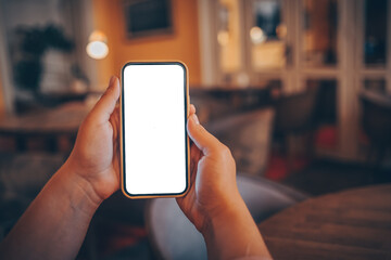 Close up of woman using cell phone,sending massages on the coffee shop