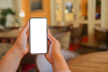 Close up of woman using cell phone,sending massages on the coffee shop