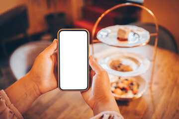 Phone isolate screen on the background of plates with food, space for text