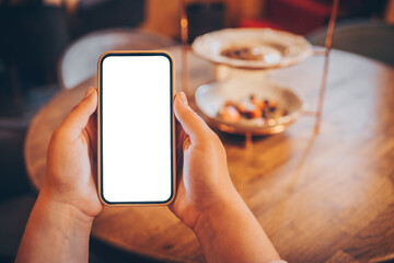 Phone isolate screen on the background of plates with food, space for text