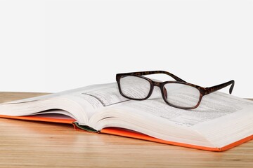 A glasses and books on a desk. World book day concept.