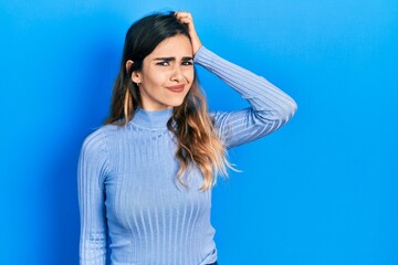 Young hispanic girl wearing casual clothes confuse and wonder about question. uncertain with doubt,...