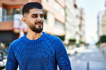 Young arab man smiling confident at street