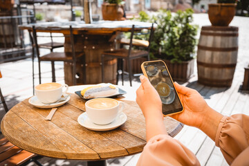 Girl takes a photo of food in a cafe