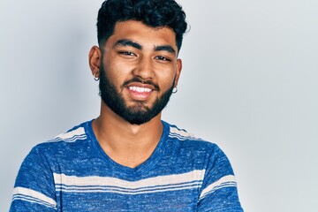 Fototapeta premium Arab man with beard wearing casual striped t shirt happy face smiling with crossed arms looking at the camera. positive person.