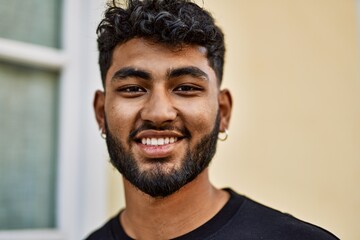 Fototapeta premium Young arab man smiling confident at street