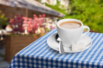 Ceramic cups of aromatic coffee with foam on the table in cafe