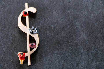Dollar inflation.Dollar sign and figurines of people on a black background. Financial Crisis and...