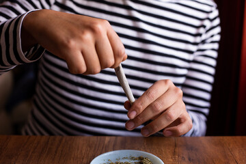 manos armando un blunt de marihuana (Cannabis). Concepto de medicina natural. © artrolopzimages