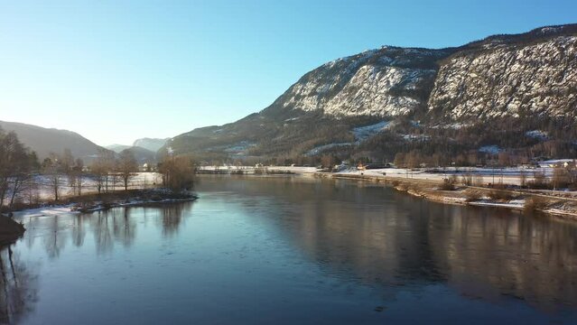 Hallingdalselve river in Nesbyen Norway - Beautiful morning aerial with sunrise above frozen landscape