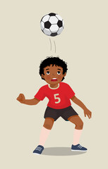 cute little African boy playing soccer practicing kicking the football with his head