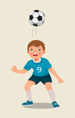 cute little boy playing soccer practicing kicking the football with his head