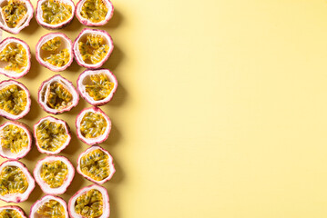 Fresh passion fruit on yellow background, Tropical fruit in summer season, Flat lay with copy space