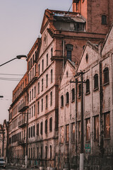 architecture photo, old factory, urban photo, street photo, pixação and graffiti, urbanism. old building, . spray graffiti , traffic sign and lamp post, background sky