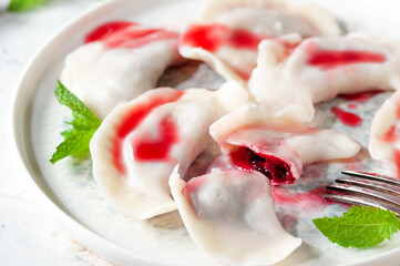 Hot dessert. Cherry dumplings with sweet sauce. Vegetarian food.
