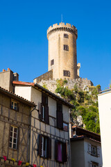 View from city streets on towers of medieval fortress Chateau de Foix, France..