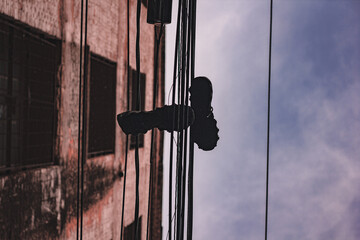urban photo, tennis shoes hanging on electrical wiring with background sky, urbanism and...