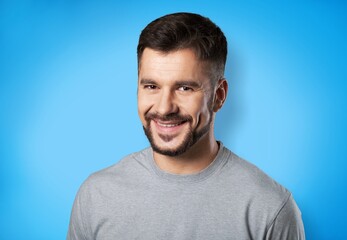 Happy man posing on the color background