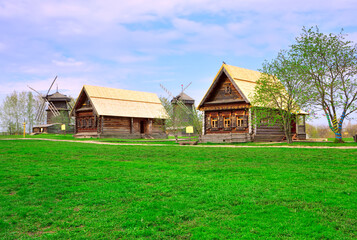 Fototapeta na wymiar Old wooden houses with windmills