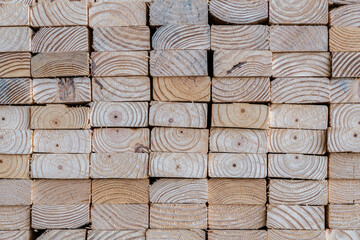Photograph of the end profile of a stack of 2 x 4 studs in a lumber yard featuring the wood grain - obrazy, fototapety, plakaty
