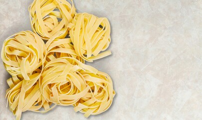 Penne pasta. Raw italian pasta on background,