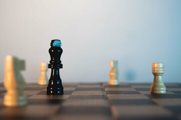 Chess game. Black king surrounded by white pieces. Victory of white chess pieces. White background. Chess game. Front view of a chessboard.