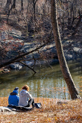 couple sitting next to a lake resting