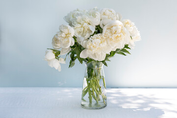 Bouquet of whites peonies on a light background.
