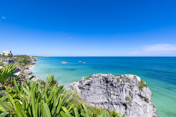 Mexico, Tulum Archaeological Zone and Mayan pyramids on scenic ocean shore.