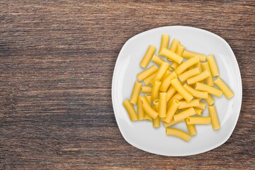 Penne pasta. Raw italian pasta on background,