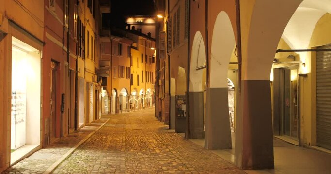 Shot of empty historic street near main square due to covid restrictions at night in Cesena, Northern Italy.