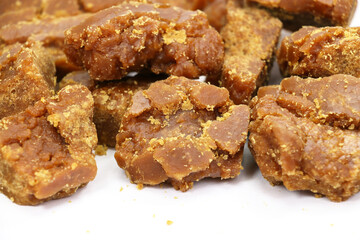 Brown Sugar Jaggery Pieces isolated on white background