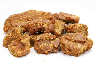 Brown Sugar Jaggery Pieces isolated on white background