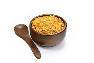 Jaggery Sugar Cane Powder in a wooden bowl with wooden spoon isolated on white background