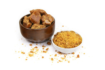 A Wooden Bowl With Jaggery Piece and Jaggery Powder bowl isolated on white background