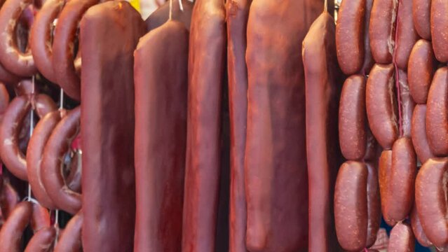 Turkish food bacon (pastirma) hanging on luxury delicatessen counter. traditional appetizer of the month of ramadan.