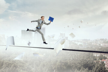 Portrait of energetic businessman jumping in open air