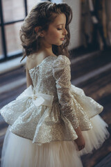 Naklejka premium Happy little girl in a beautiful dress. High quality photo