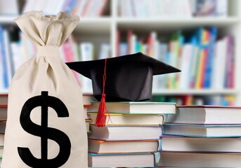 Saving money for college tuition fees, education concept, bags, a black graduation cap, a...