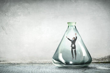 Businessman trapped in a clear glass bottle